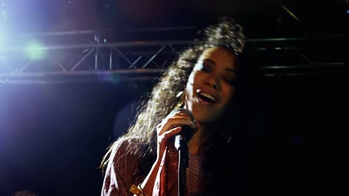 Dynamic Singer Performing with Passion on Stage at Night