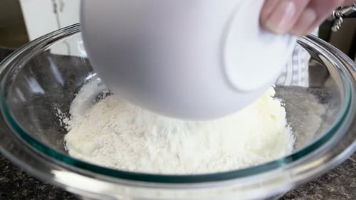 Adding Flour to Mixing Bowl While Baking