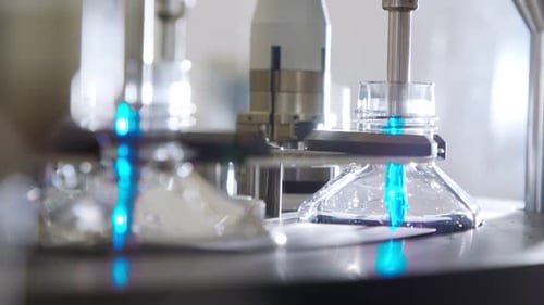 Automated pharmaceutical manufacturing line, bottles filled with liquid