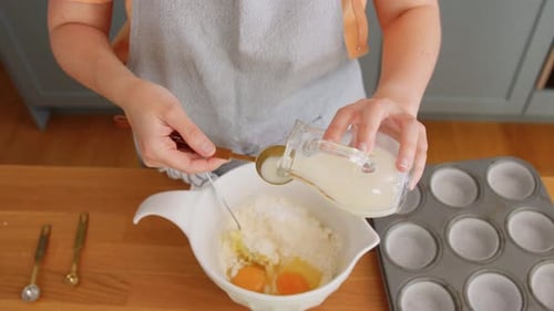 Woman Making Batter and Pouring Milk to Bowl