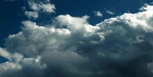 Billowing Clouds Moving Across a Blue Sky