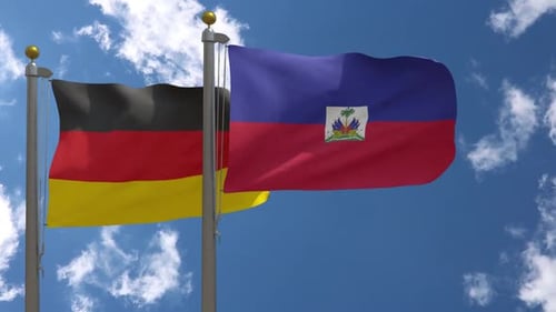 Waving German and Haitian Flags on Flagpoles Against Blue Sky