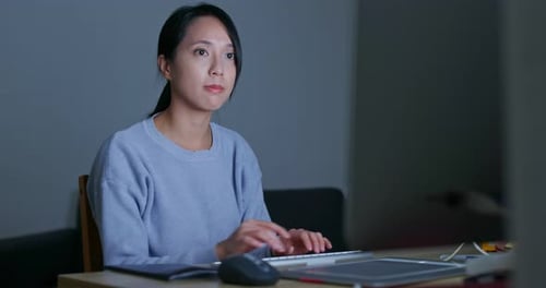 Woman work on computer at home in the evening