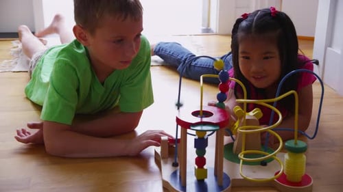 Young girl and boy playing with toy. Shot on RED EPIC for high quality 4K, UHD, Ultra HD resolution.