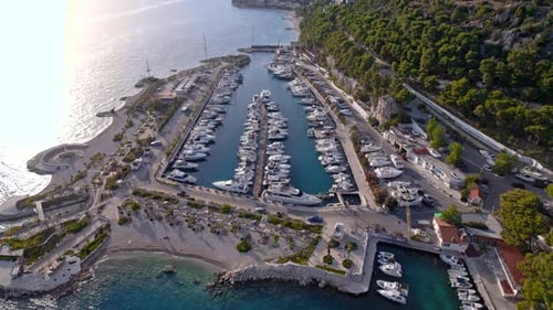 Drone Aerial of the Marina with Yachts Near the Mountains in Sunset Light