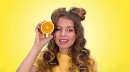 Smiling Woman Posing with Orange Slice