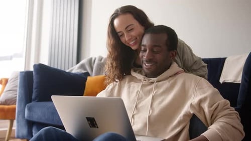 Couple Video Calling on Laptop at Home