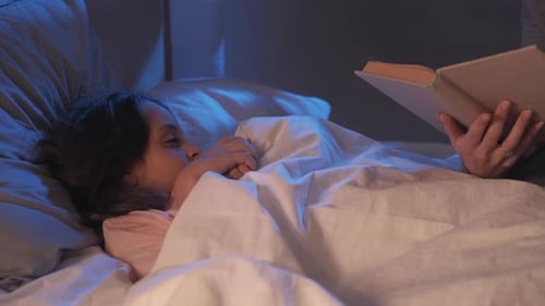 Child Listens to Story Before Sleep at Night