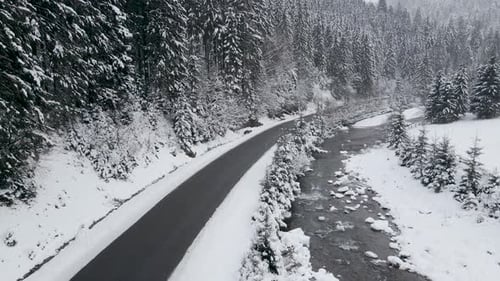 Aerial View Drone Moving Above the Frozen River in Mountains