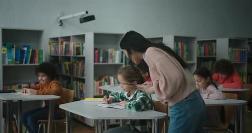 Asian Teacher Uses Tablet Checking Learning Process of Kids