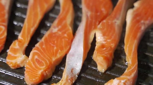 Grilling Salmon Fillet on Smoking Grill. Close Up Salmon Fillet Barbecuing on Charcoal Grill.