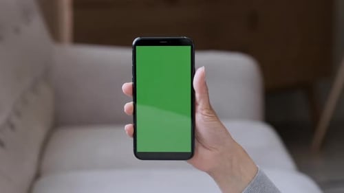 Handheld Camera: Point of View of Woman at Phone with Green Screen for Copy Space