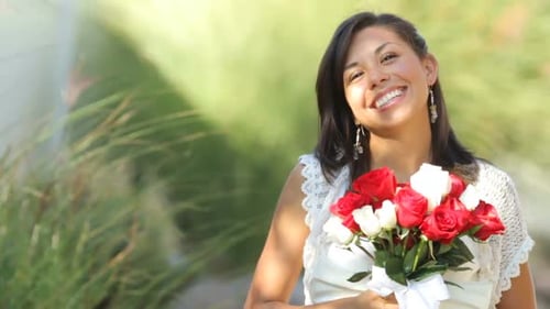 Smiling Woman Holds Bouquet of Red and White Roses