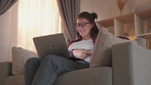 Woman Video Chatting on Laptop at Home