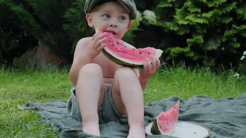 Happy Child Eating Watermelon on a Summer Day