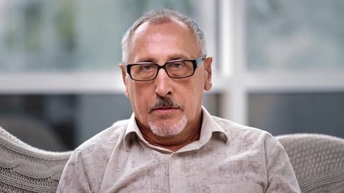 Mature Man Looking at Camera Indoors