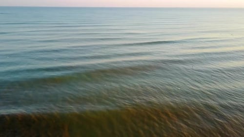 Perfect aerial view showing the sea and the coastline at sunset.