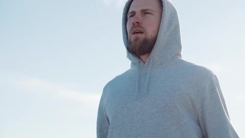Man Exercising Jump Rope Wearing Gray Hoodie Outdoors