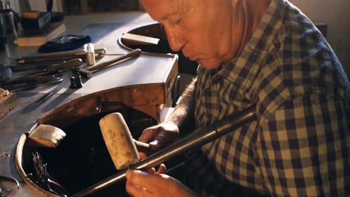 Man Working with Tools at Workbench