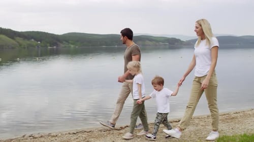 Family of Four Walking by the Lake