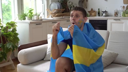 Enthusiastic Sports Fan Celebrates Victory at Home