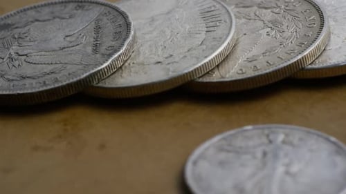 Antique Silver Coins Close Up on Brown Surface