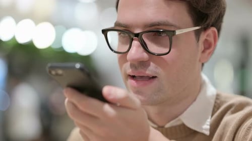 Close Up of Young Man Talking on Phone