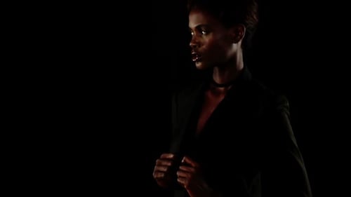 Stylish Woman Posing in a Black Suit