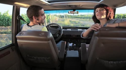 Young Couple Smiles on Country Road Trip