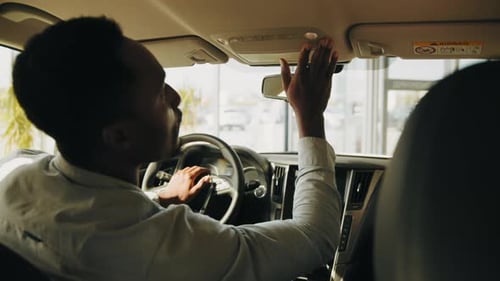Male Client Choosing New Vehicle at Modern Showroom