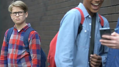 Multiracial Teens Scrolling Smartphone and Mocking Classmate, Bullying Online