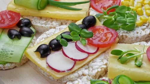 Rice Cakes Topped with Cheese and Fresh Vegetables