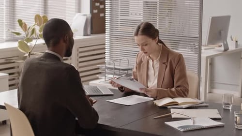 Black Man Giving Resume to HR Manager at Job Interview