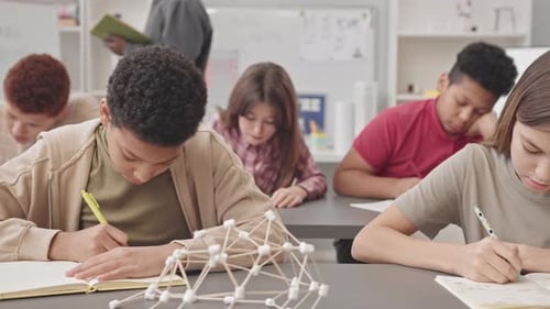 Students Studying and Writing in a Classroom