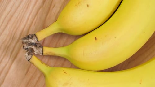 Bright Yellow Bananas on a Wooden Surface