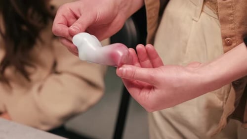 A woman occupied with hand made candles production