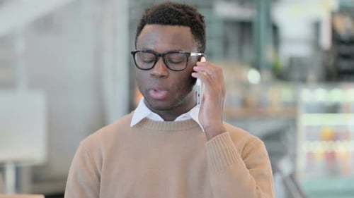 Adult Talking on Phone Indoors