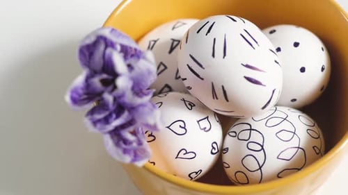 Hand Decorated Easter Eggs in Yellow Bowl