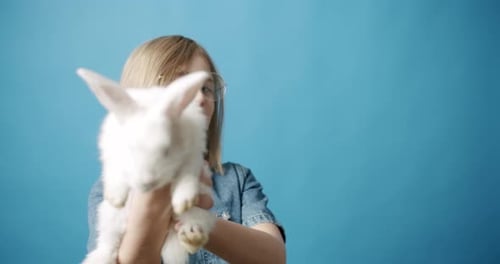 Happy Child Holding a Fluffy White Bunny