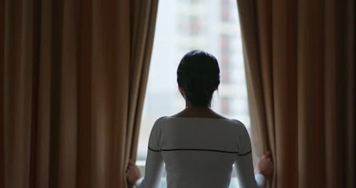 Woman open the curtain