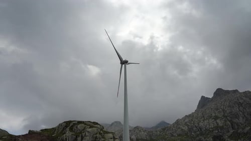 Wind Turbine Spinning in a Mountainous Rural Landscape