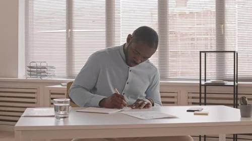 Man Working and Brainstorming in Bright Office