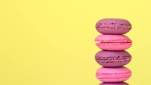 Stacked Pink and Purple Macarons on Yellow