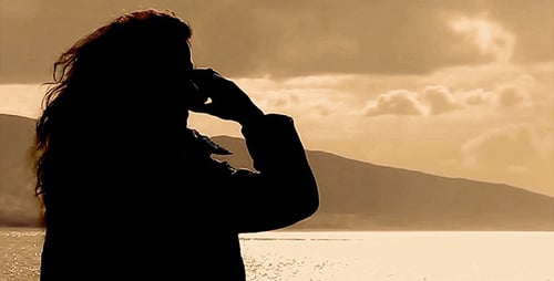 Woman Silhouette Talking on Phone at Sunset Lake