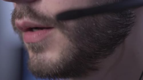 Close-up Lips of Serious Bearded Caucasian Man in Headset Talking. Unrecognizable Young Professional