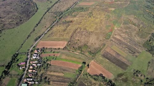 Aerial view of village in beautiful rural landscape with after harvest