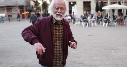 Senior Man Dancing in City Plaza