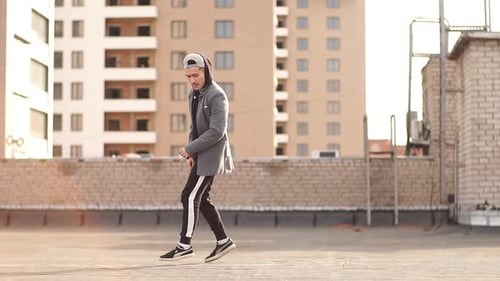 Young Man Breakdancing on Urban Rooftop