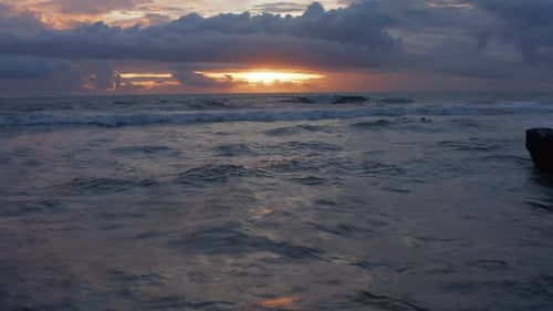 Retreating View of Waves on the Ocean During Sunset