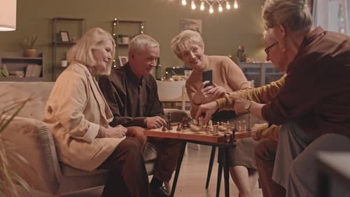 Seniors Enjoying a Game of Chess Together Indoors